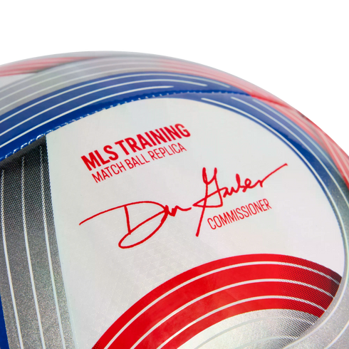 Close-up of an MLS training soccer ball with text reading "MLS TRAINING MATCH BALL REPLICA" and the signature of the league's commissioner.