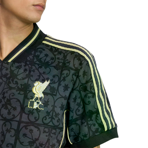 Close-up of a patterned dark grey Liverpool FC jersey with light green stripes and a golden club crest.