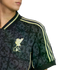 Close-up of a patterned dark grey Liverpool FC jersey with light green stripes and a golden club crest.