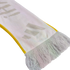 A close-up of a white knitted scarf with yellow edges and white tassels, featuring faint grey letters printed on the fabric.