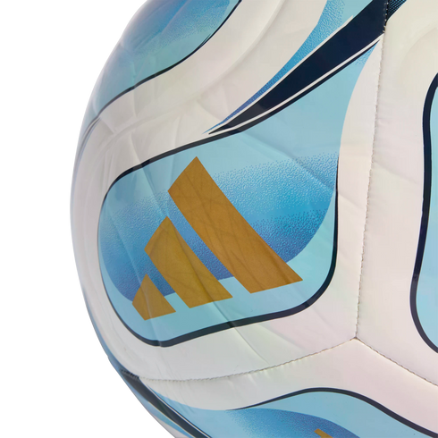 Close-up of an Adidas soccer ball with white, light blue, and dark blue curved panels and three gold stripes.