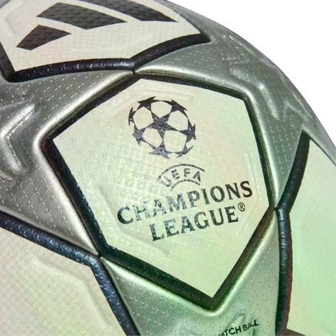 Close-up of a silver and white Adidas UEFA Champions League soccer ball, showcasing the official logo and textured star pattern.