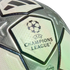 Close-up of a silver and white Adidas UEFA Champions League soccer ball, showcasing the official logo and textured star pattern.
