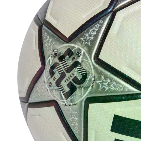 Close-up of a white and silver textured soccer ball with a star panel featuring a 20th-anniversary "Official Match Ball Supplier" logo.