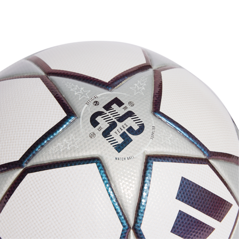 Close-up of a white and silver soccer ball with iridescent star panels. A central logo celebrates 23 years as the official match ball supplier since 2001.