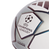 Close-up of a silver and white UEFA Champions League replica soccer ball featuring the official starball logo and textured panels.