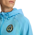 A person wears a light blue Philadelphia Union hooded jacket featuring the team's circular crest on the chest.