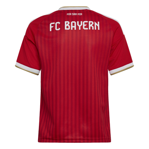 Back of a red FC Bayern Munich soccer jersey featuring white "FC BAYERN" and "MIA SAN MIA" lettering with white and gold trim on the sleeves.