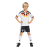 A smiling young boy wearing a Germany national team soccer kit, standing with hands on hips against a black background.