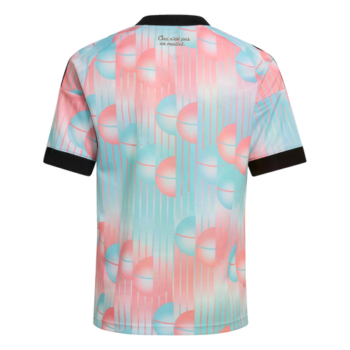 Back view of a short-sleeved jersey with a pink and blue sphere pattern and black trim. Text at the neck reads "Ceci n'est pas un maillot."