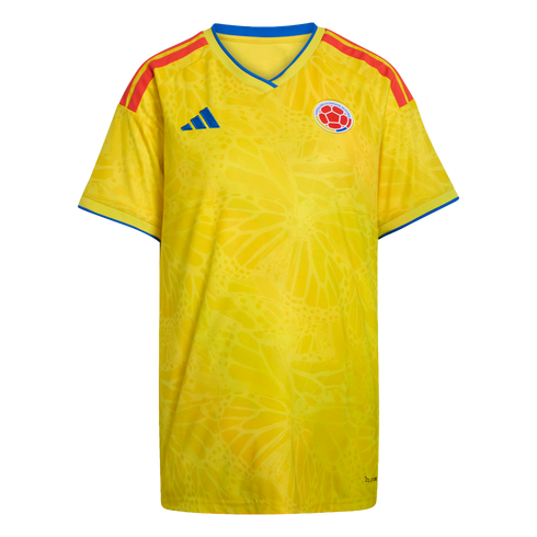 A yellow Colombia national team soccer jersey featuring red shoulder stripes, blue trim, and a subtle tonal butterfly wing pattern.