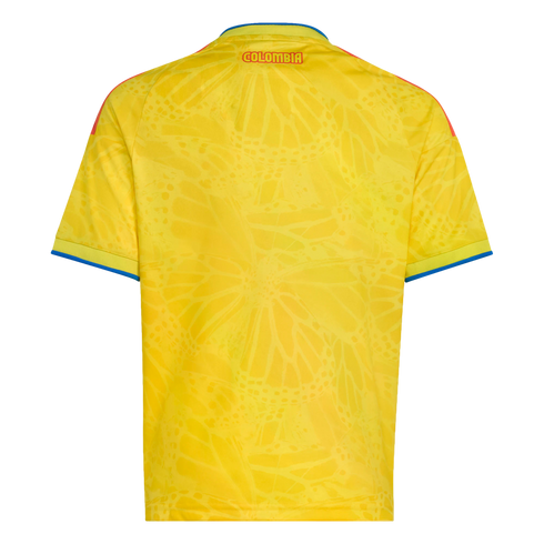 Back view of a yellow Colombia jersey featuring a tonal butterfly pattern, red "COLOMBIA" text at the top, and blue trim on sleeves and collar.
