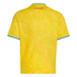 Back view of a yellow Colombia jersey featuring a tonal butterfly pattern, red "COLOMBIA" text at the top, and blue trim on sleeves and collar.