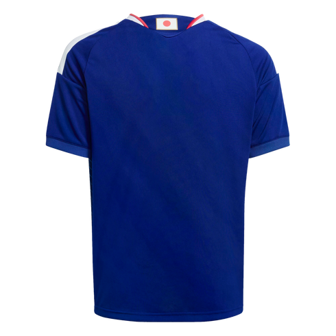 Back view of a short-sleeved blue soccer jersey with white stripes on the shoulders and a small Japanese flag on the back collar.
