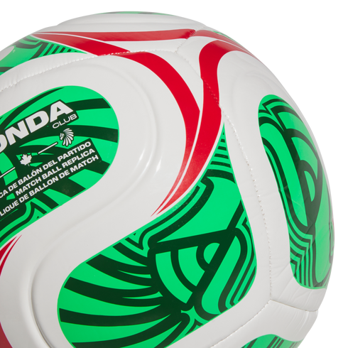 Close-up of a white soccer ball with green and red patterns, featuring "MATCH BALL REPLICA" text and an indigenous-style logo.