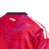 Close-up back neck view of a red and purple patterned jersey with a navy collar, "Pura Vida" script logo, and white shoulder stripes.