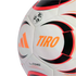 A close-up of a white Adidas Tiro soccer ball with orange, black, and red graphics on its textured surface against a black background.
