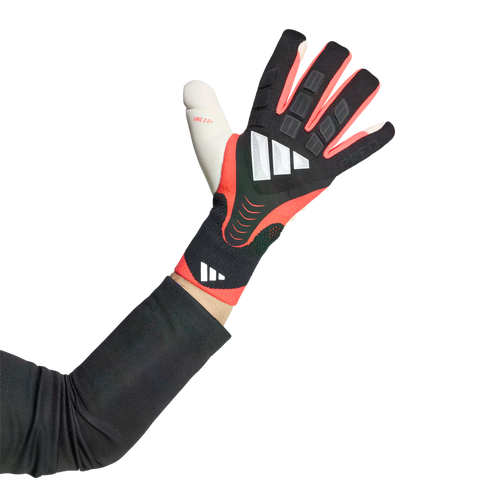 An arm wearing a black and red Adidas goalkeeper glove with white logos against a black background.