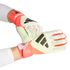 Person wearing white and coral Adidas Predator goalkeeper gloves, adjusting a wrist strap against a black background.