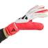 Red and white Adidas goalkeeper glove worn on a hand, set against a solid black background.