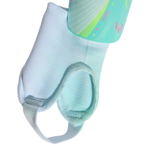 Light blue shin guard sleeve with ankle padding and a foot strap. A teal Messi-branded shin guard is partially visible at the top against a black background.