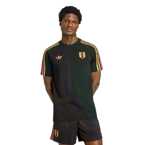 A man models a black Adidas kit with neon pink, orange, and yellow stripes and FPF crests on a black background.