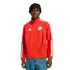 Man wearing a red Adidas track jacket with a Chicago Fire FC crest and blue jeans, standing against a black background.