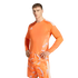 A man wearing a bright orange Adidas goalkeeper kit with geometric patterns on the jersey and shorts, posing against a solid black background.