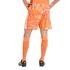 Back view of a person in a patterned orange soccer uniform, tall orange socks, and black cleats, standing with hands on hips against a plain black background.