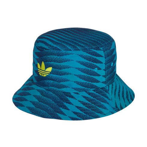 An Adidas bucket hat with a teal and navy digital zebra print and a bright yellow trefoil logo on the front, set against a black background.