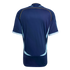 Back view of a navy blue short-sleeved jersey featuring light blue curved side panels, yellow shoulder piping, and white-striped cuffs.