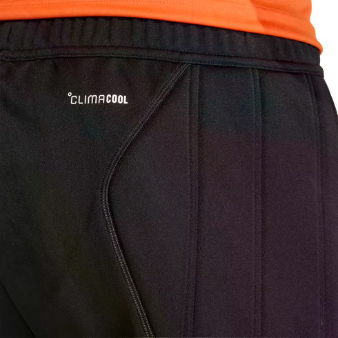 Close-up of black Adidas ClimaCool athletic pants with an orange shirt visible at the top waistband.