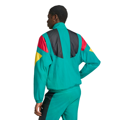 A person from the back wearing a teal tracksuit with red, yellow, and black color-block patterns, against a white background.