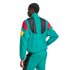 A person from the back wearing a teal tracksuit with red, yellow, and black color-block patterns, against a white background.