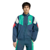 A man in a blue, green, and white adidas Italy tracksuit with the national team crest, standing against a plain white background.