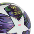 Close-up of a UEFA Champions League replica match soccer ball with purple and green patterned star panels.