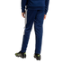 Rear view of navy blue Adidas track pants with white side stripes, paired with black soccer cleats.