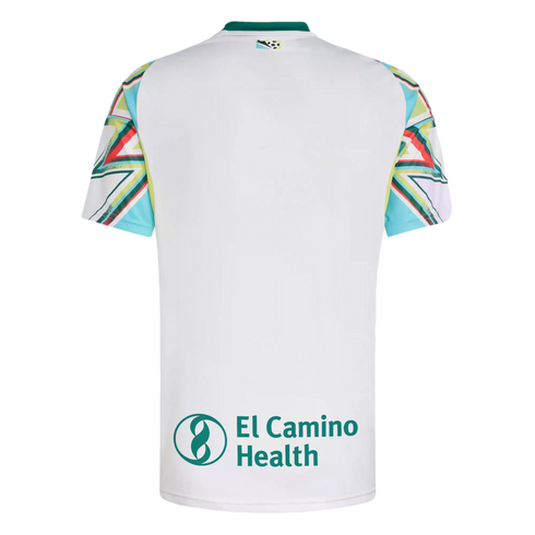 Back of a white soccer jersey with colorful geometric patterns on the sleeves and the "El Camino Health" logo on the lower back.