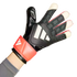 Close-up of a hand wearing a black Adidas Predator goalkeeper glove with three white stripes and a red wrist strap, set against a white background.