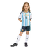 A young girl with braided hair posing in a full Argentina national football team kit, including a #10 jersey, navy shorts, white socks, and black cleats.