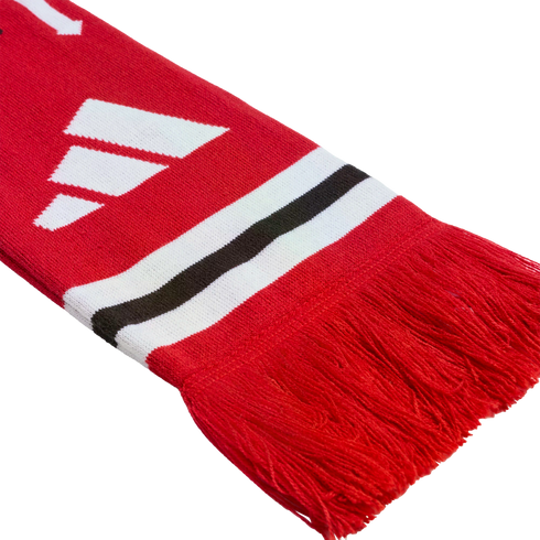 Red knitted scarf featuring a white three-bar logo, horizontal black and white stripes, and red fringe at the end.