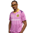 A man wearing yellow-tinted sunglasses poses in a pink and purple Borussia Dortmund soccer jersey with yellow accents.