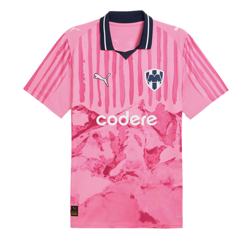 Pink Monterrey soccer jersey with a navy collar, vertical stripes on the top half, and a mountain graphic on the lower half. Features Puma and Codere logos.
