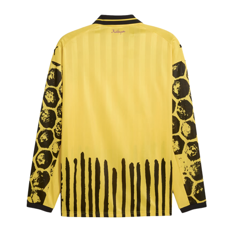 Back view of a yellow long-sleeved jersey featuring black honeycomb-patterned sleeves and vertical paint-stroke stripes along the hem.