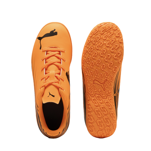 Top and sole views of an orange Puma indoor soccer shoe with black logos on a black background.
