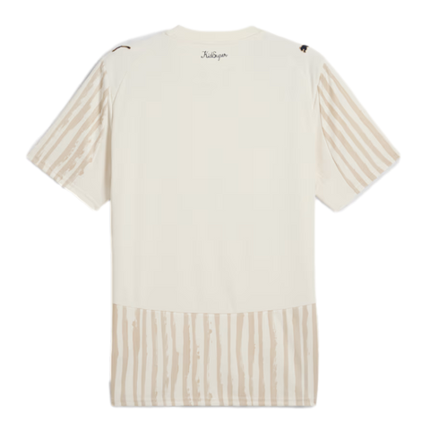Back view of a cream-colored t-shirt with tan brushstroke-style stripes on the sleeves and hem, featuring the "KidSuper" logo below the collar.