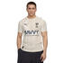 A man wears a cream-colored Al Hilal football jersey with tan vertical stripes and the "SAVVY GAMES GROUP" logo against a black background.