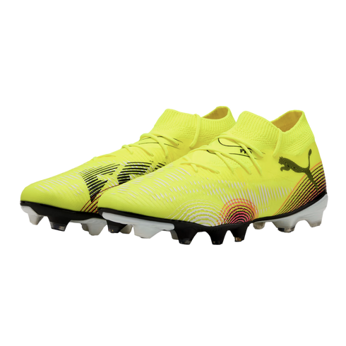 Pair of neon yellow Puma soccer cleats with black and white patterns and a pink circular graphic, set against a solid black background.