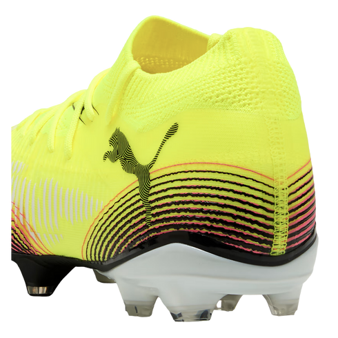 Rear side view of a neon yellow Puma soccer cleat featuring a black cat logo, curved pink and black stripes, and a white sole with clear studs.