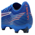 Rear view of a blue Puma Ultra soccer cleat featuring orange "ULTRA" text on the heel and white and orange stripe accents on a textured upper.